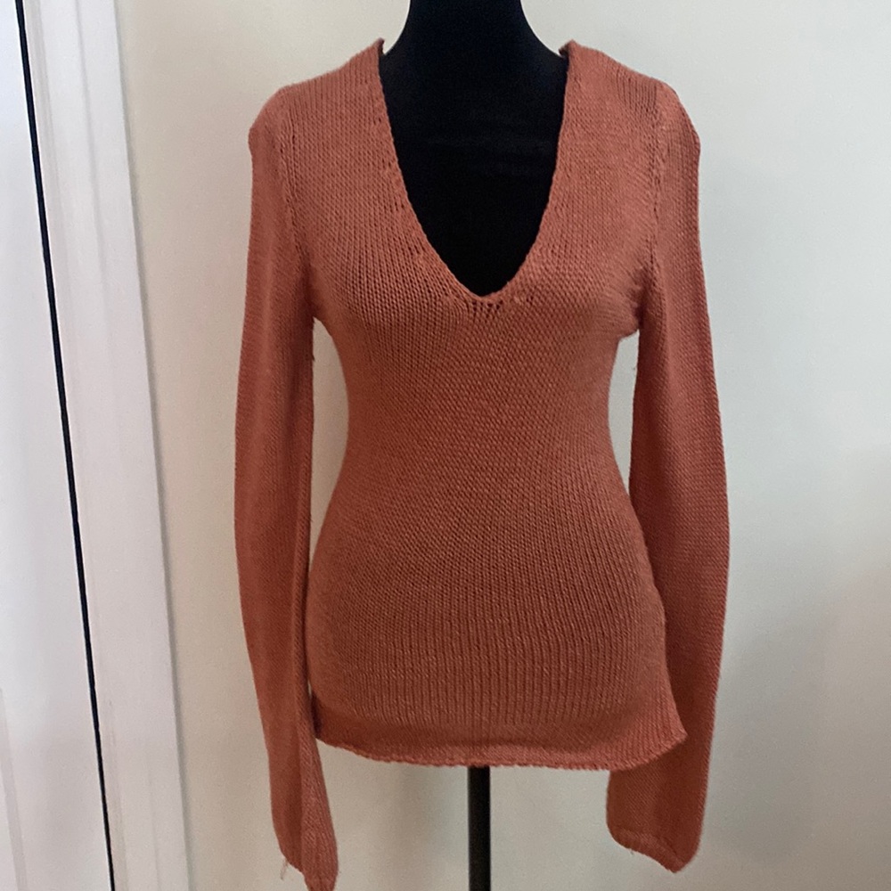 Beautiful coral colored, deep V neck, long sleeved, thin sweater. Spring color!